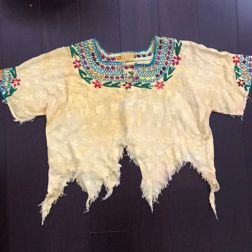 Embroidered distressed crop top.